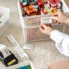 woman holding mobile label printer sticker with kids toys