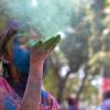 A-girl-blowing-colors-celebrating-holi-colors-best-seattle-area-Holi-events-kids-families-redmond-eastide