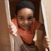 boy peeking out of a cardboard box