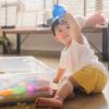 child playing in sand sensory bin