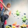 young boy climbing at an indoor rock climbing gym in Seattle