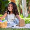 girl sitting with an Easter basket in the grass