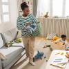 mom and kids picking up toys