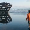 boy looking at the peter iredale shipwreck while camping in Oregon