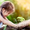 Girl helping plant during Earth Day event