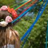 A girl with flowers in her hair participates in a May Day pole dance