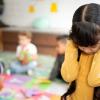 preschool girl frustrated covering her ears