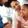 little girl at a primary health checkup with mother and doctor
