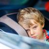 little boy feeling sick in car seat