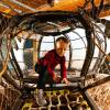 young child climbing in a rope climber at Hands on Children's Museum, which is hosting spring break activities this weekend