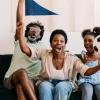 A family excitedly cheers while watching a FIFA World Cup soccer game
