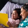 mother with kid reading in bed