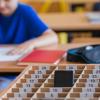School kids placing putting phones away during class