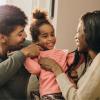 married couple and child in living room