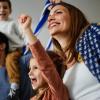 family cheering while watching game at home