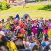 crowd watching a marching bad with big instruments play during Honk Fest West in Seattle