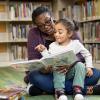 parent and child reading at library