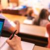 Student using AI app on mobile phone in classroom