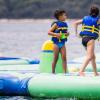 Children playing on inflatable floating water park