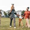 A happy African American family hold hands as they celebrate Juneteenth.