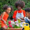 mom and kids planting flowers
