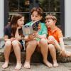 PJ LIbrary: Kids reading a book on their front porch
