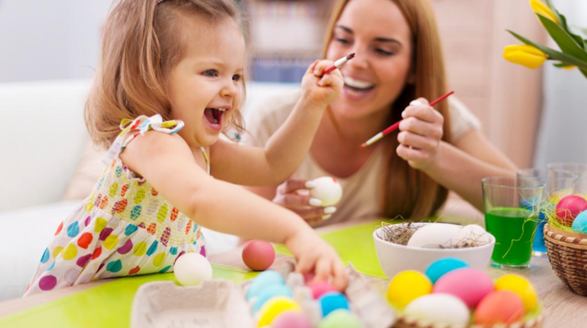 Mother and daughter painting Easter eggs
