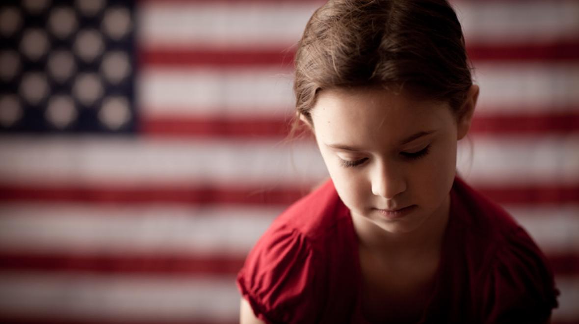 Girl with American flag in background