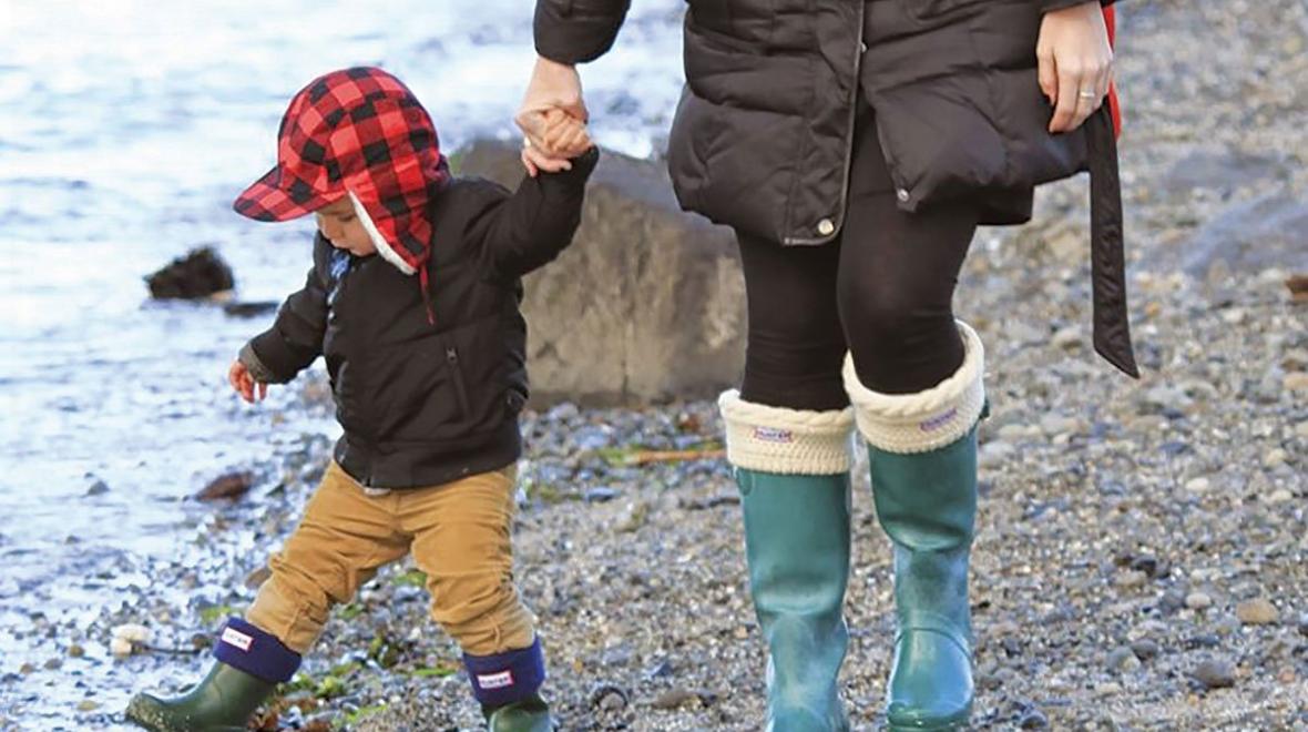 Boy and parent on beach