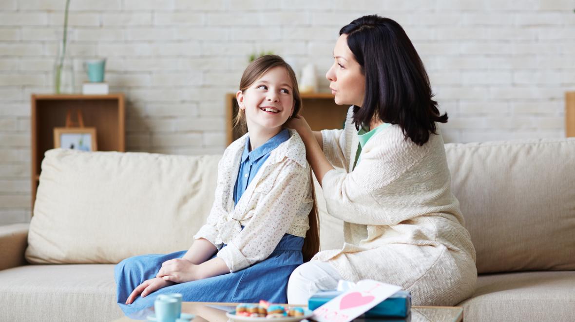 mom and daughter talking on couch