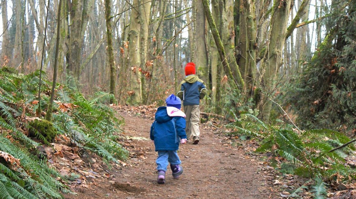 Best places to walk in Seattle include Discovery Park where kid hikers hit the trail in fall and winter