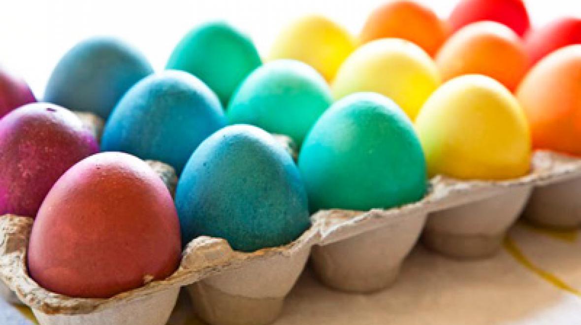 Confetti filled Easter egg ideas line a egg container in rainbow colors