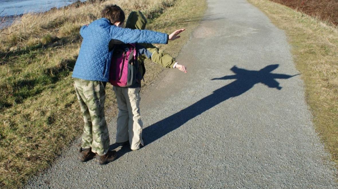 kids make a shadow on a spring hike near seattle at Padilla bay
