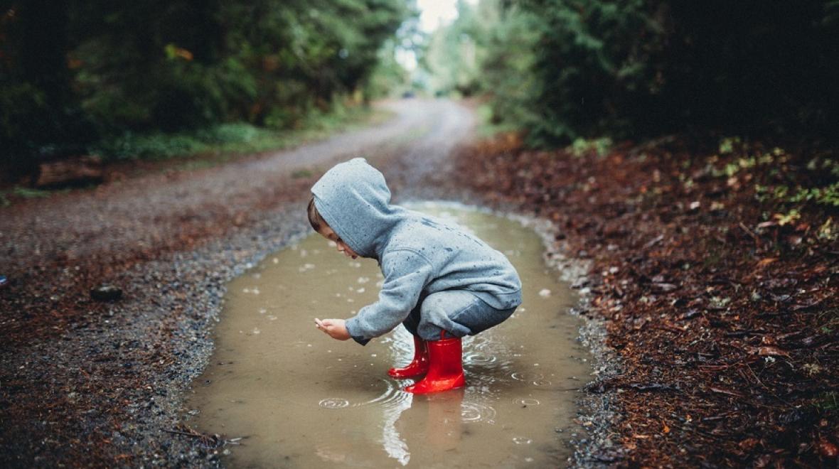 Child playing in a puddle
