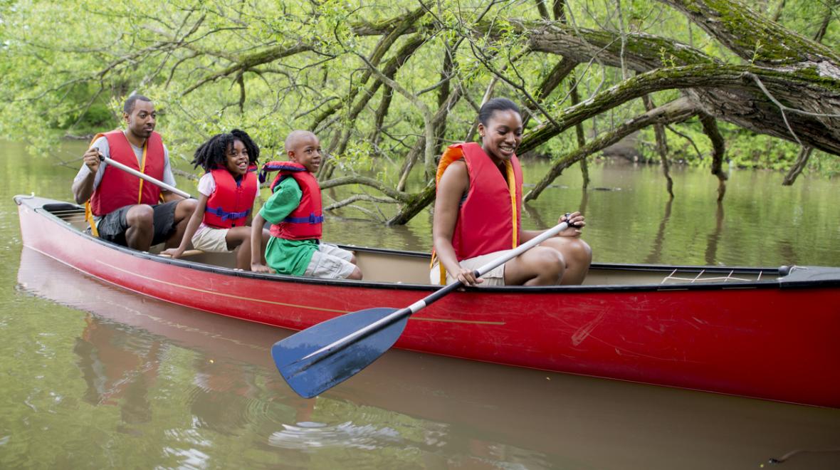 Family canoeing in lake
