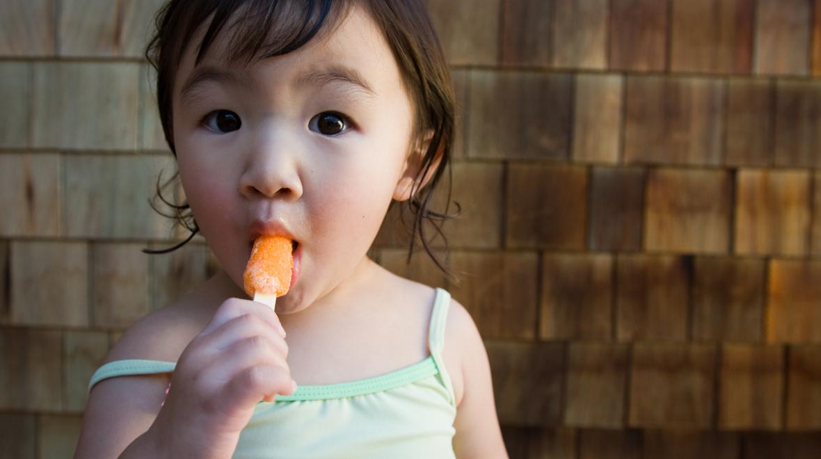 Girl with popsicle play inside when it's too hot out