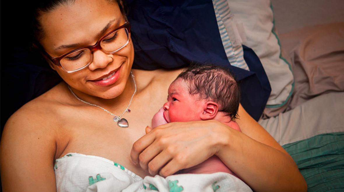 A mother cradles her newborn shortly after birth
