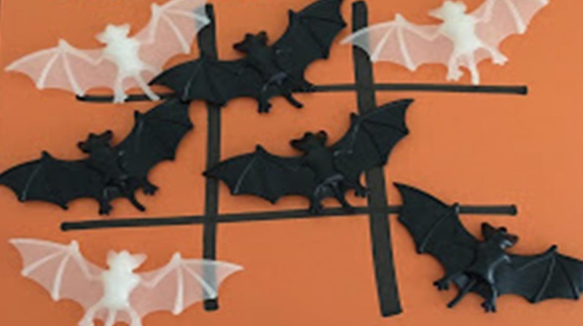 tic tac toe using black and white bats on an orange paper is a halloween game for kids