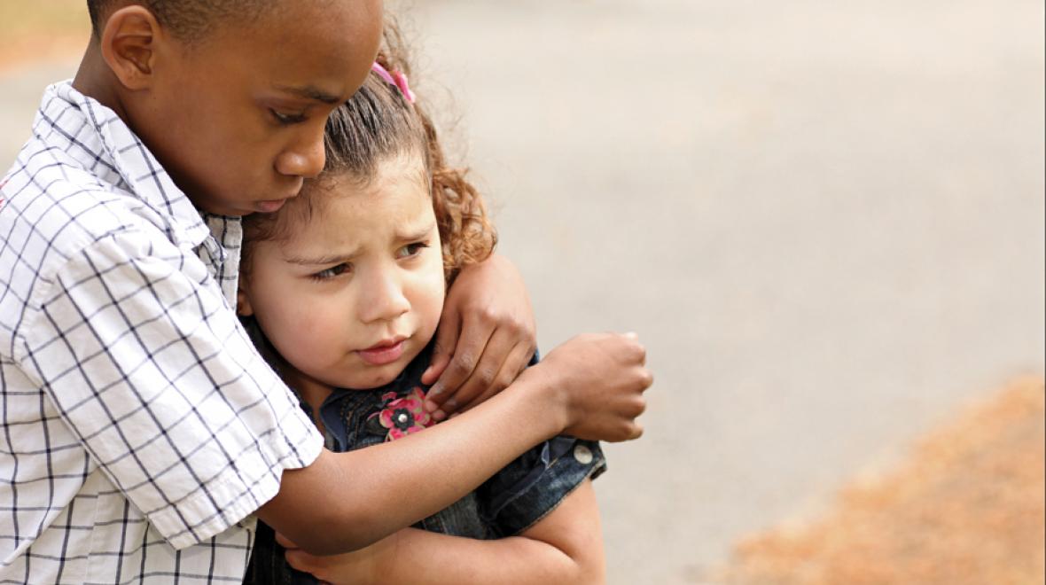 little boy hugging comforting nervous sad little girl