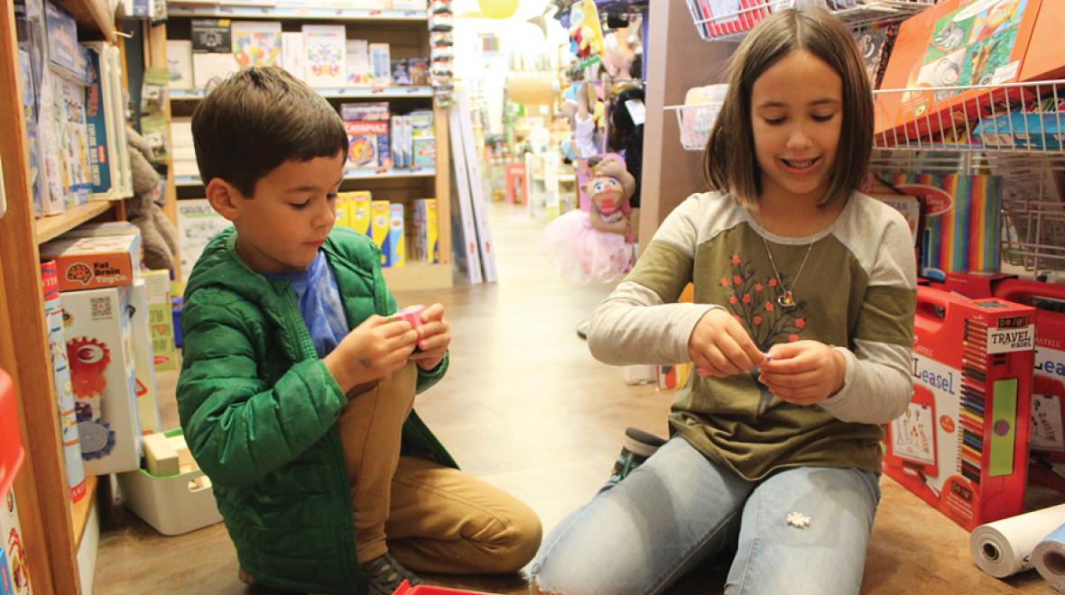 kids trying out Plus-Plus construction pieces at Teaching Toys in Tacoma’s Proctor District