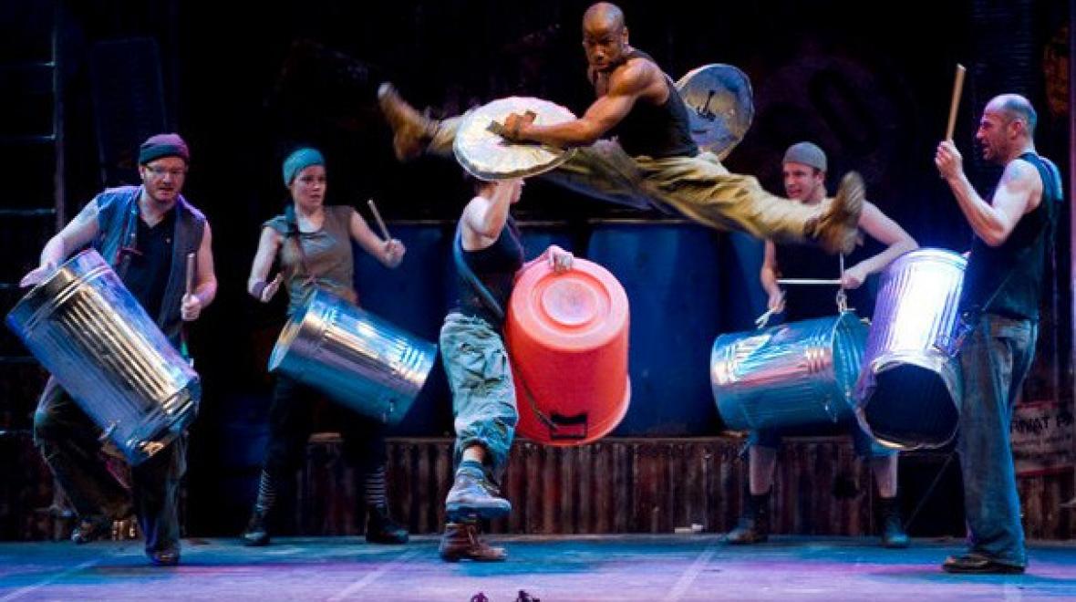 Performer soars through the air in STG Presents' "STOMP"