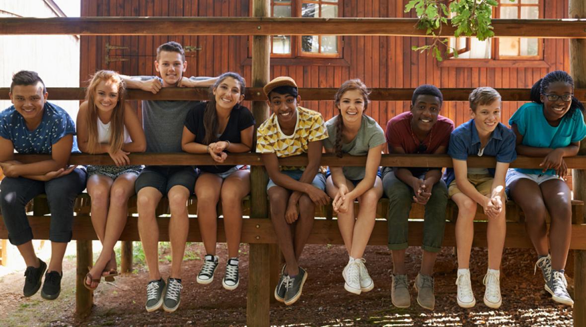 tweens hanging out on cabin doorstep at overnight summer camp