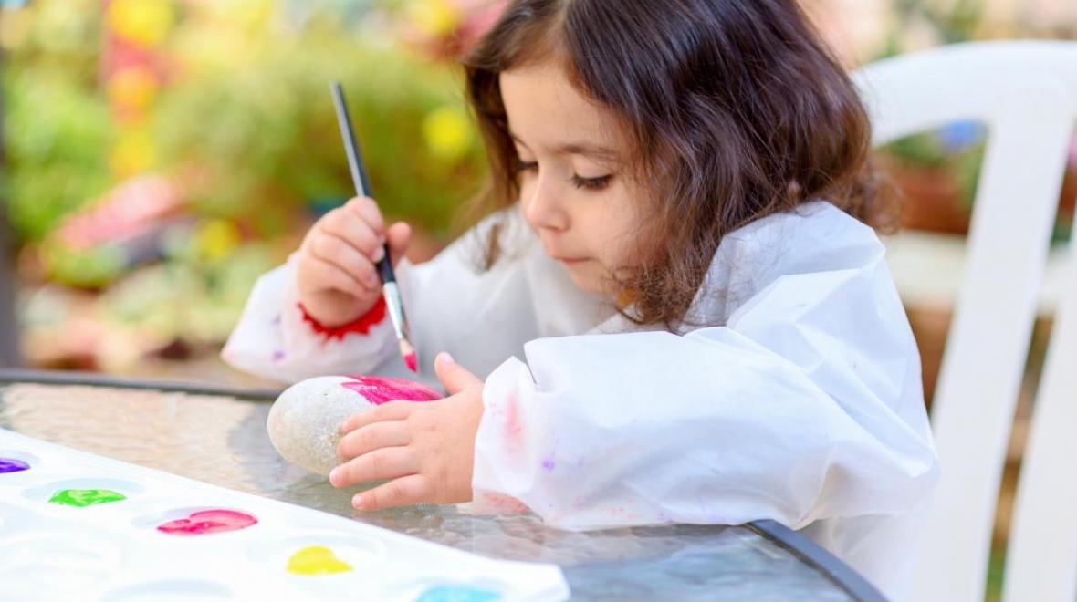girl painting rocks