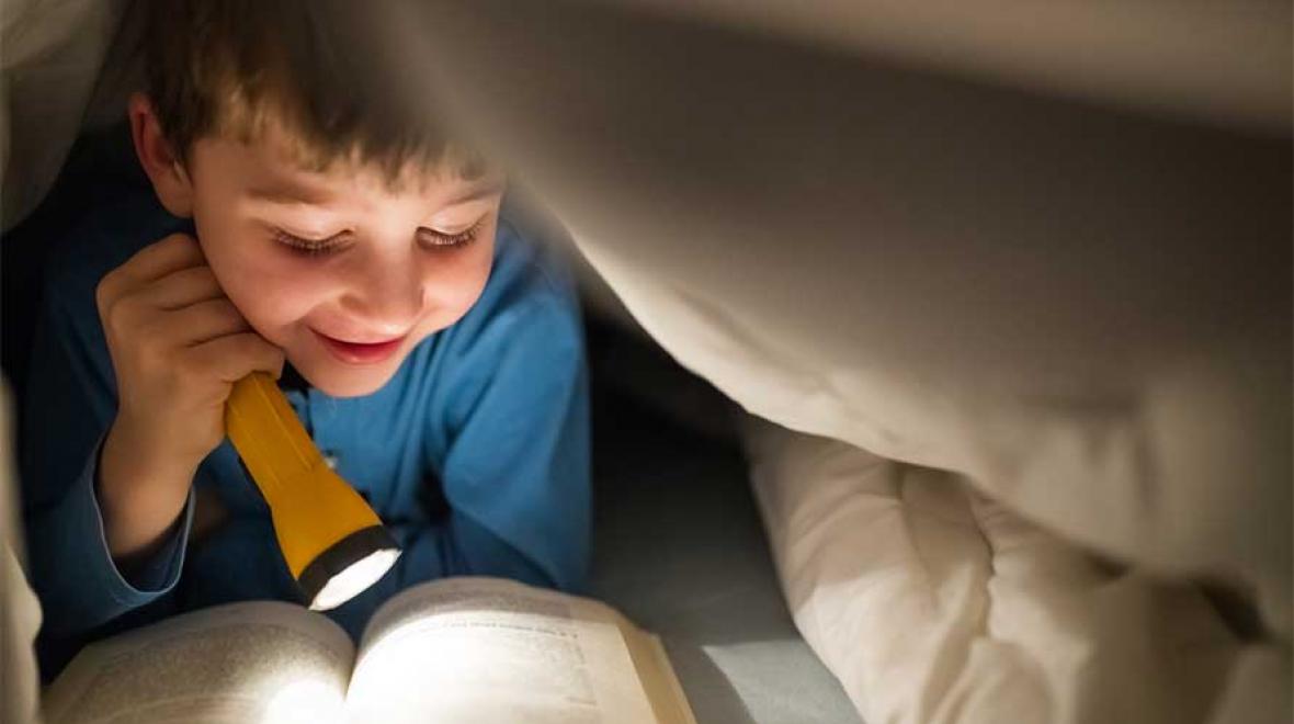 kid reading in bed