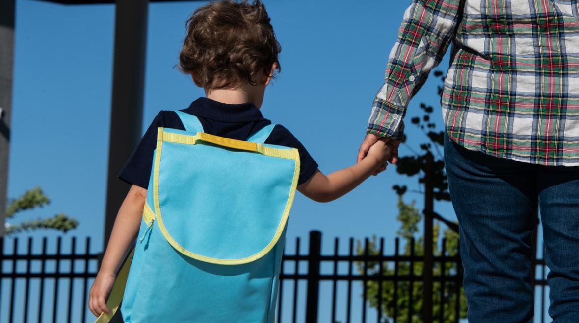 little boy with backpack going back to preschool