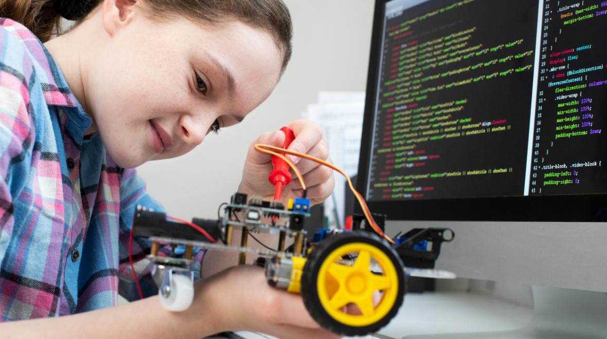 Young girl programs a robot