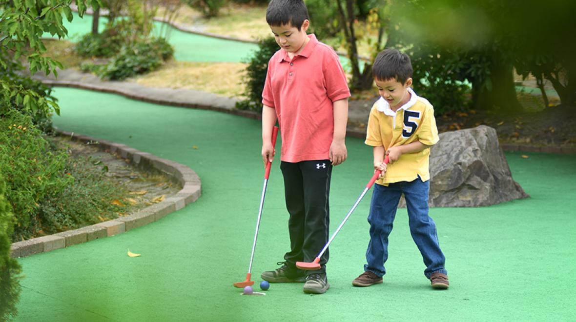 Brothers playing mini golf at Interbay