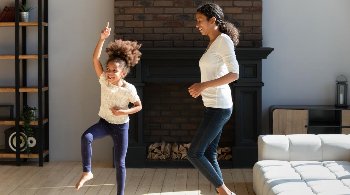 mom and daughter dancing living room family dance party at-home recess movement ideas remote school