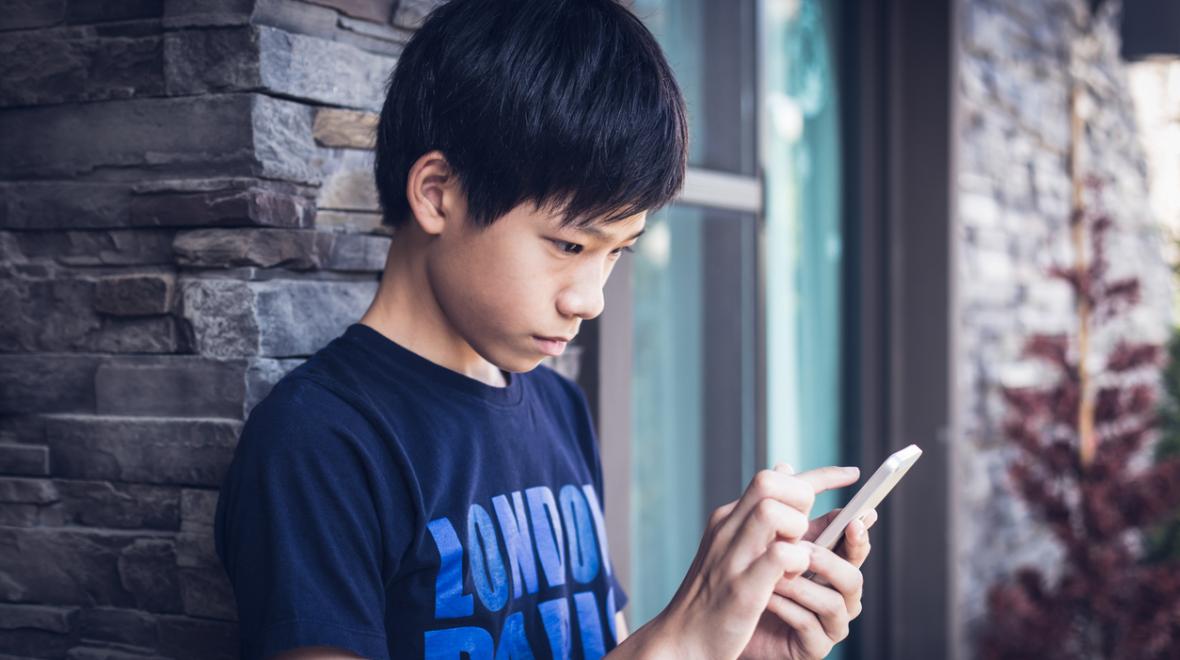 Asian teenager using smartphone