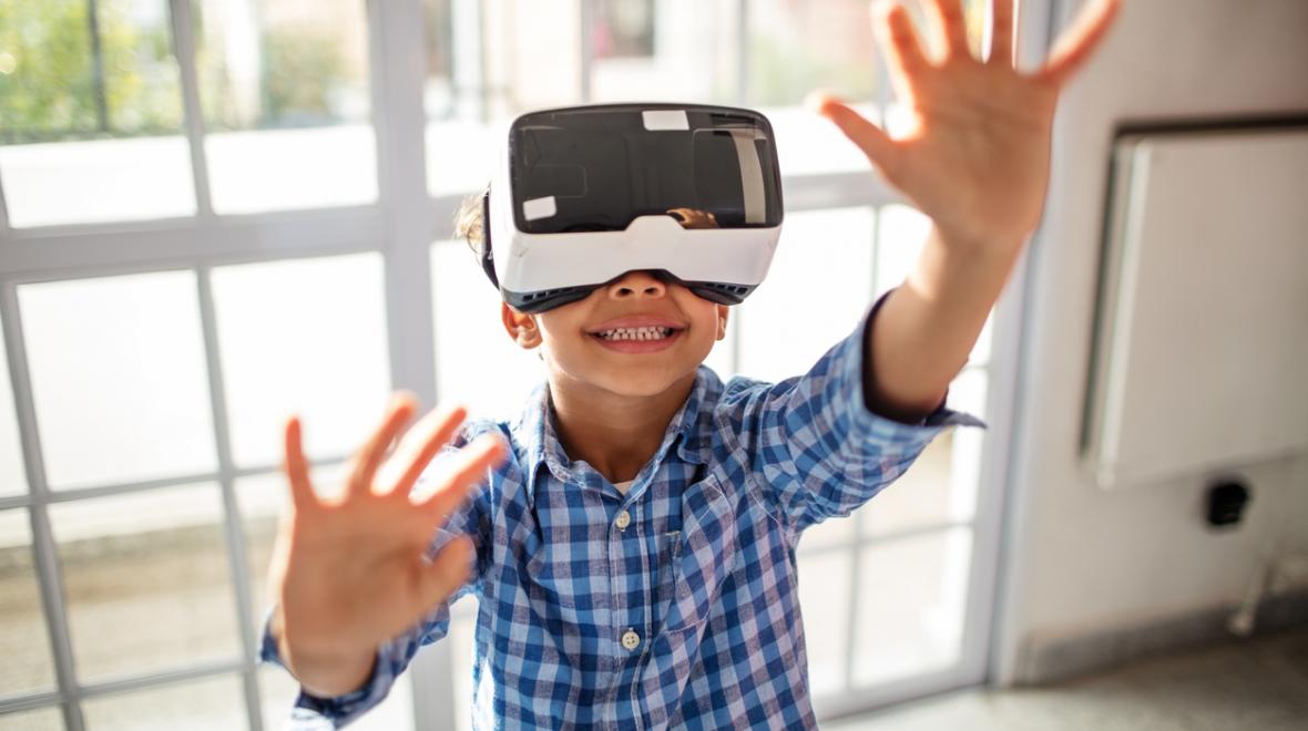 Young boy wearing a virtual reality headset